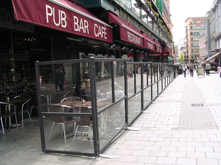 pub bar cafe red sign with outdoor glass dividers and seating area